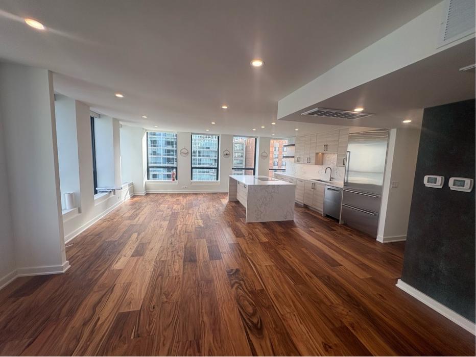 Modern open kitchen and living area remodeled by Post Services Inc, general contractor in Northfield, IL.