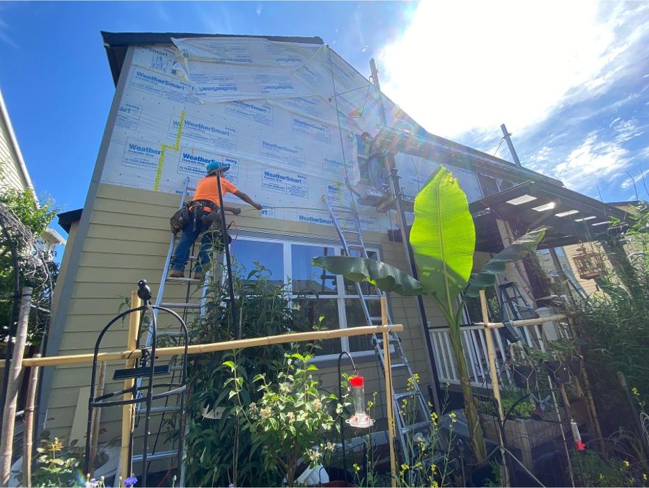 Professional siding installation in progress by KVN Construction in Clackamas, OR, featuring exterior wall preparation and fiber cement siding installation on a residential home.