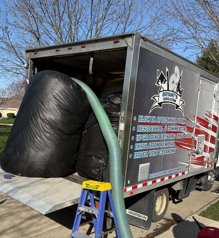 Bryant's Insulation crew preparing for an attic insulation project with our professional blown-in insulation truck and removal equipment.
