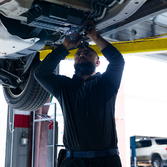 Mechanic, Wilson, working underneath a vehicle at Japanese Auto Repair