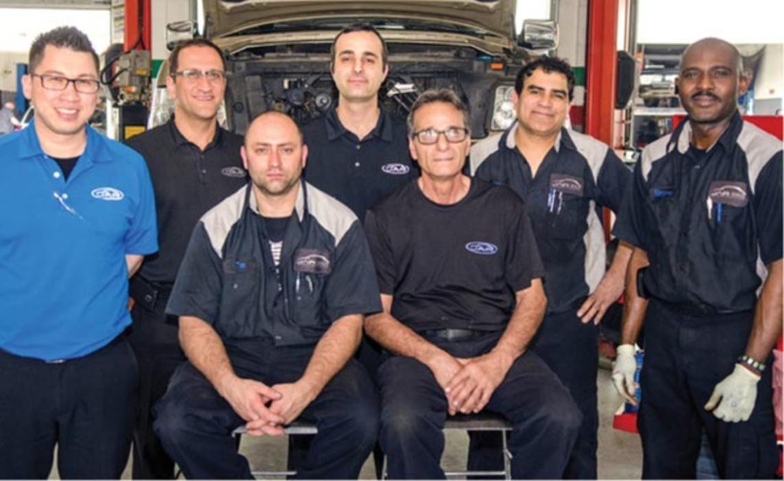 An original Japanese Auto Repair team photo from several years ago
