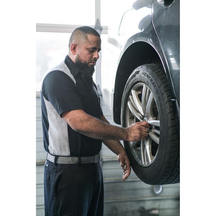 ASE certfied auto technician servicing wheels and tires on a customer car