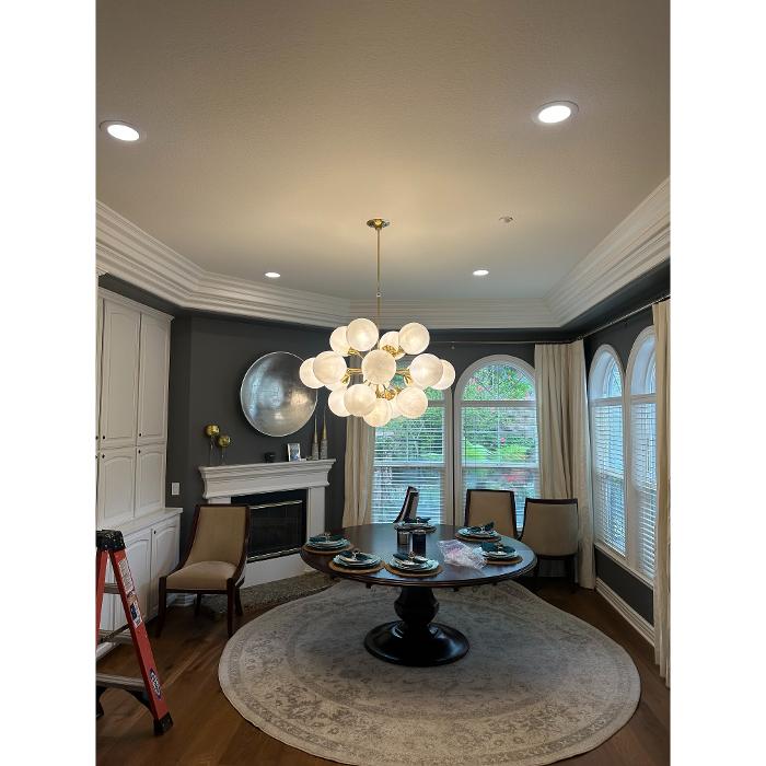 Modern dining room chandelier installation, San Diego.