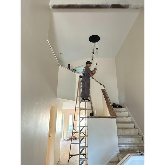 Custom pendant light installation over a staircase by Cbass Electric, San Diego.