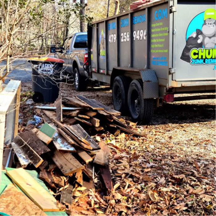 Chums Junk Removal dump trailer loaded with furniture and household junk for removal.