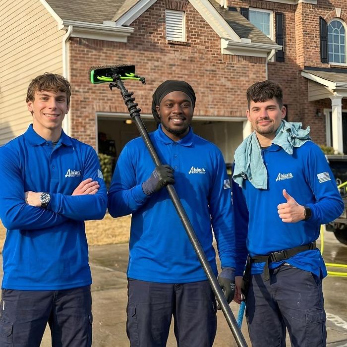 The exterior cleaning team at Aidan's Home Services as they finish up a driveway pressure wash and home soft wash.