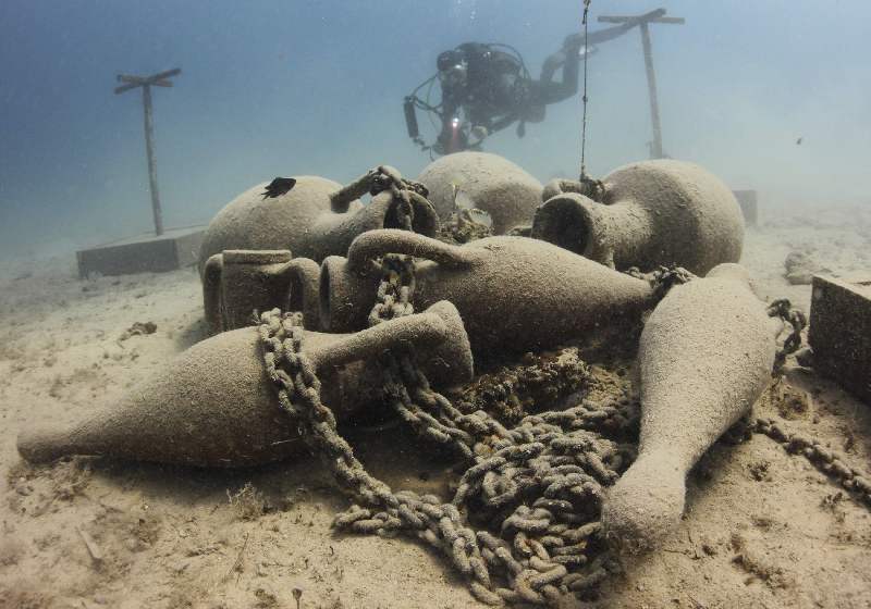 A diver swims next to a replica of the Northern Adriatic amphoras in Historical Underwater Park in Mali Losinj July 24, 2014. The park features 11 different exponents, placed between 5 and 15 metres deep in the water, which testify the rich history of Losinj island and its region. REUTERS/Antonio Bronic (CROATIA - Tags: SOCIETY TRAVEL TPX IMAGES OF THE DAY)