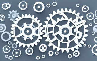 Various stages of a project represented by different sized gears interlocking with each other