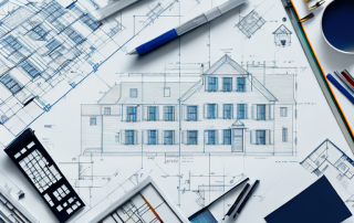 A drafting table with architectural tools