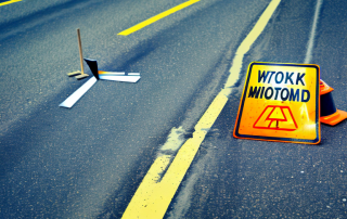 A road maintenance scene with tools such as a broom