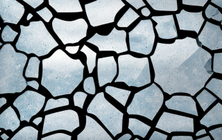 A car's windshield with visible cracks and chips