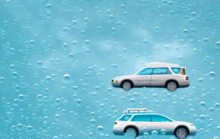 Several different types of cars gleaming under a shower of bubbles and foam