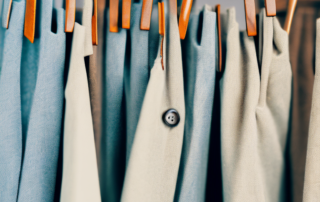 Several stylish men's hemp trousers displayed on hangers
