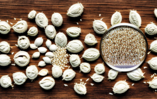 Unpeeled hemp seeds scattered on a wooden table
